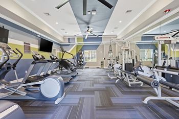 Modern fitness studio with tvs